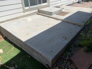 Back patio was sinking due to poor compaction and water intrusion, causing a large tripping hazard. Raised the concrete to its corrected height/slope, and removed tripping hazard.