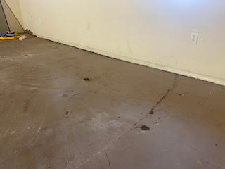 Sunken concrete indoor slab to be raised using a mudacking system in Lafayette, CO