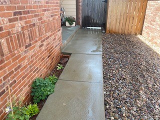 Raised the sidewalk to corrected height and slope, eliminating tripping hazards.